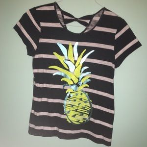 A striped shirt with a pineapple on it